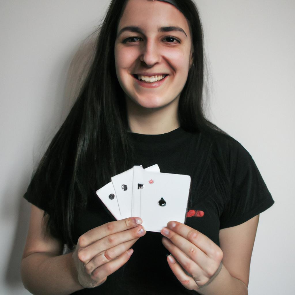 Person holding playing cards, smiling