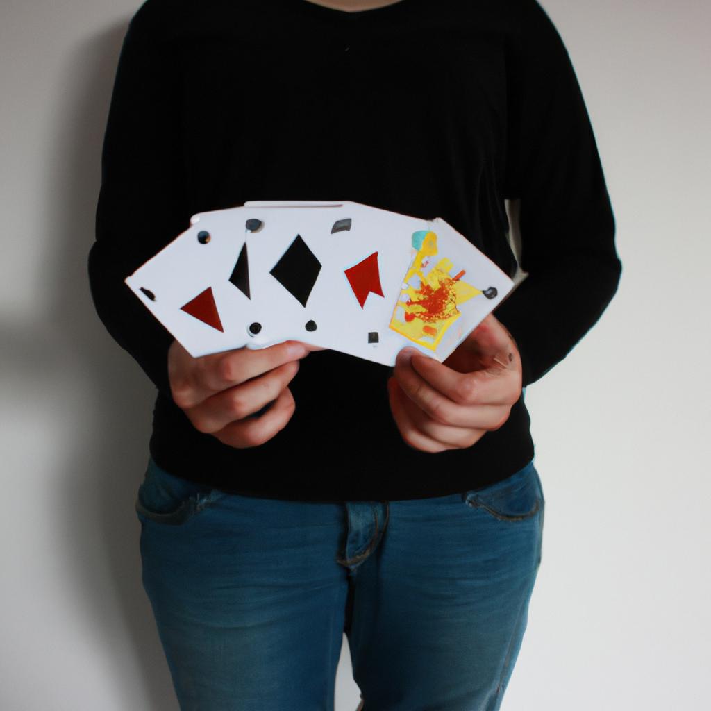 Person holding cards and board