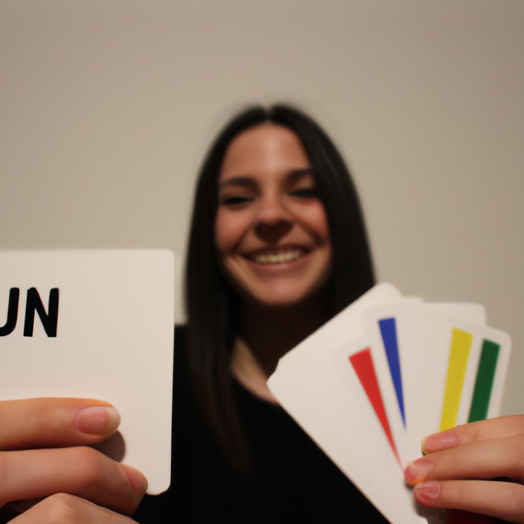 Person holding UNO cards, smiling
